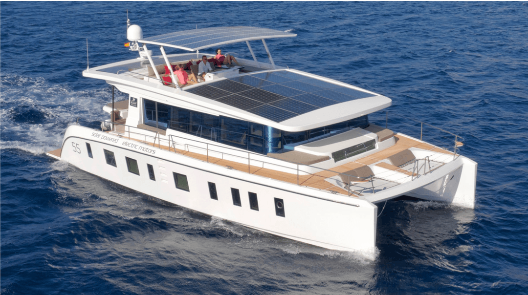Photo of a catamaran on the water with solar panels on the roof