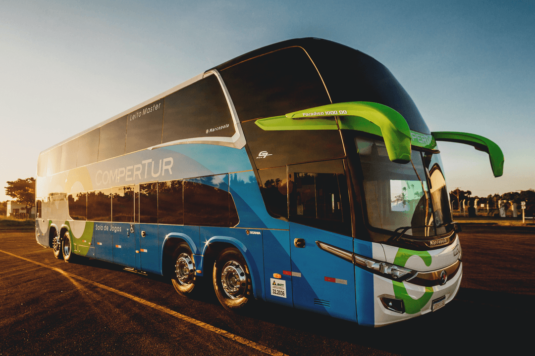 Photo of a 2-storey bus with a sunset